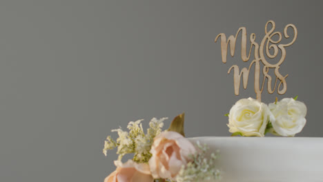 Close-Up-Of-Wedding-Cake-Against-Grey-Studio-Background-At-Wedding-Reception-1